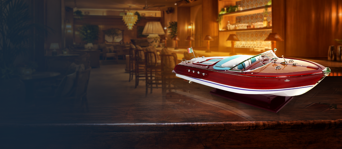 Warmly lit waterfront hospitality interior with a handcrafted wooden boat model